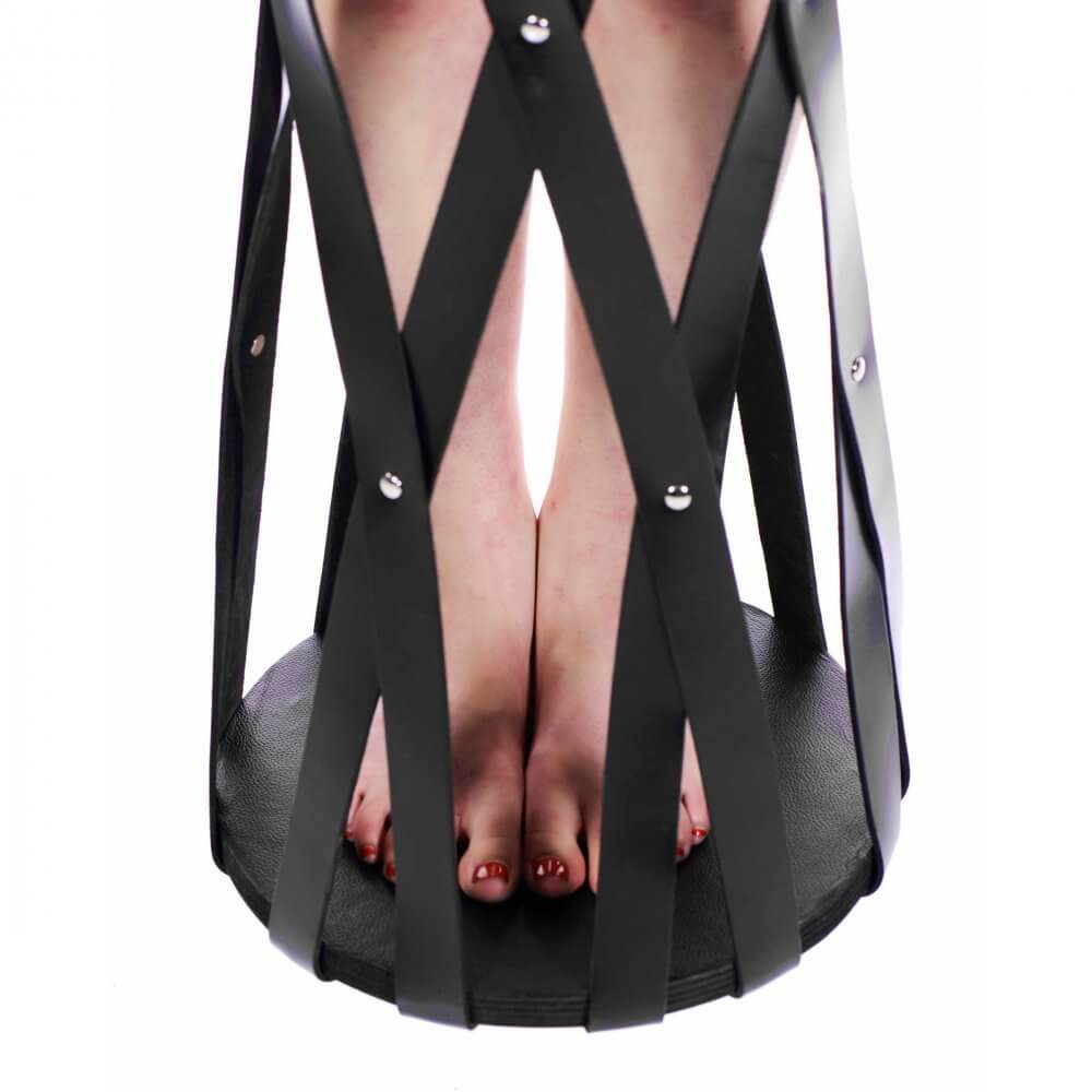 BDSM leather strap cage, suspended for erotic exploration and play.